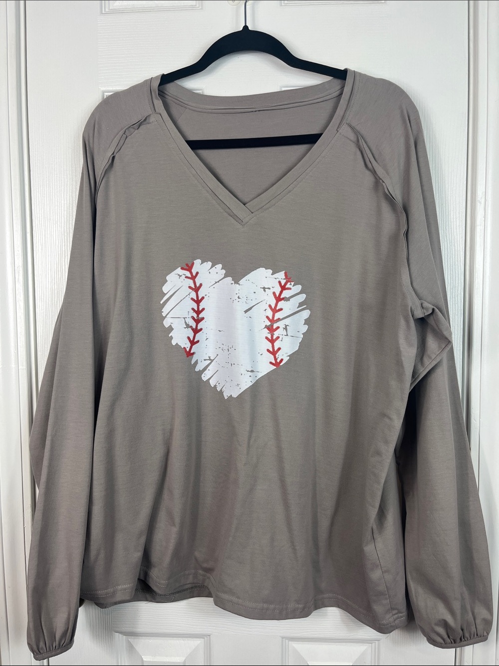 Grey long sleeved tee shirt with baseball shaped as a heart. Bust 23.5”.